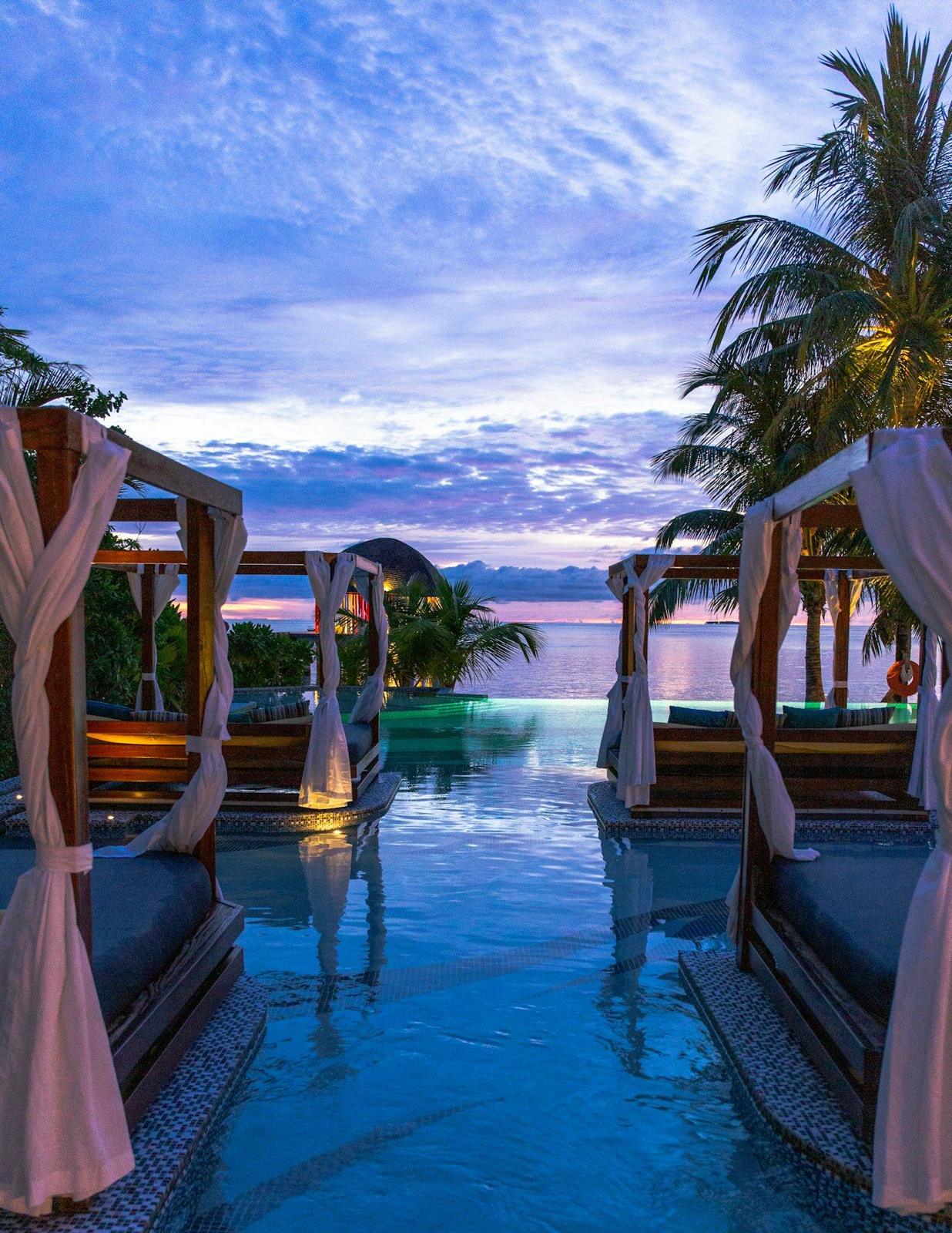 Resort cabanas beside an infinity pool