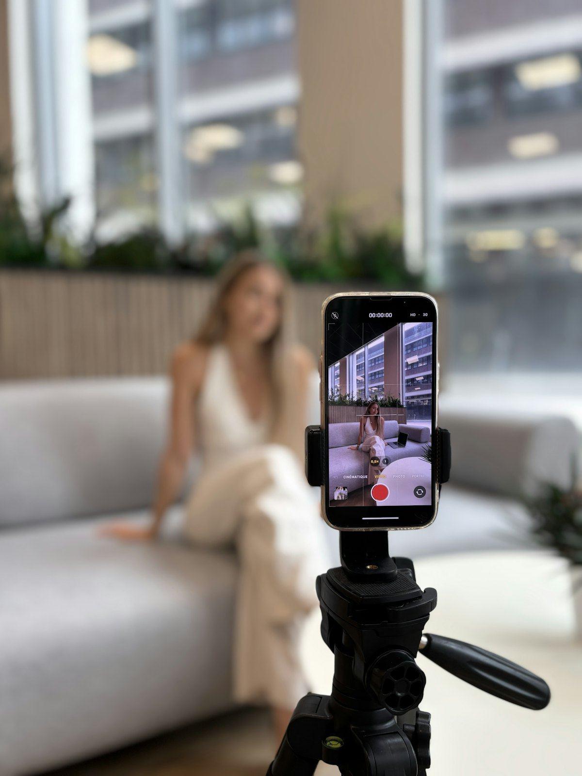 A creator films herself on a phone tripod